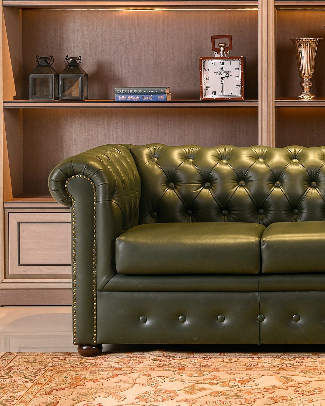 Leather Sofa Living Room Ideas: 8 Styles and Layouts 4 Green tufted leather Chesterfield sofa in a living room with built-in shelving