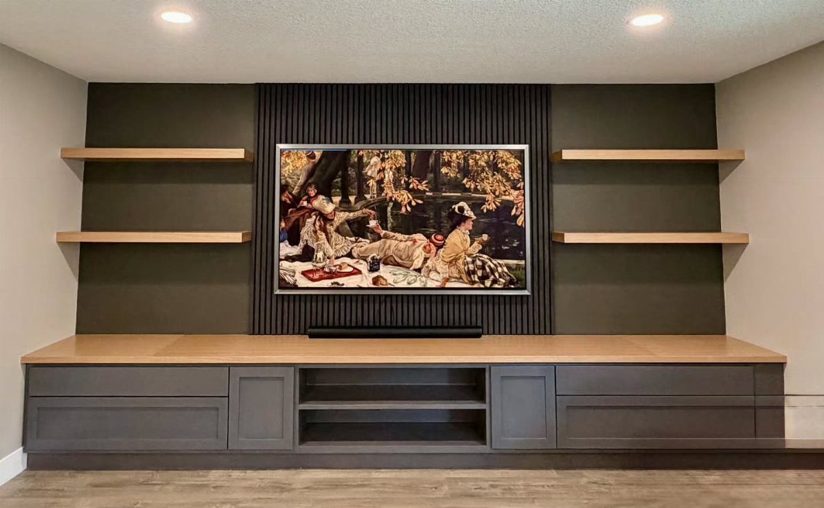Dark grey accent wall with vertical black wood paneling and light wood floating shelves.