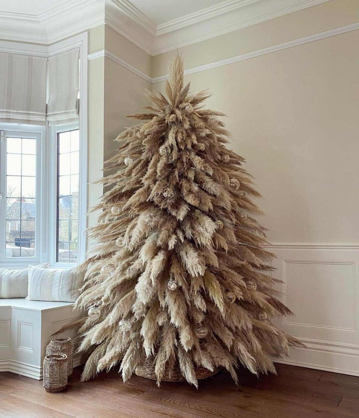 Pampas grass Christmas tree with white ornaments in a bright, modern living room.