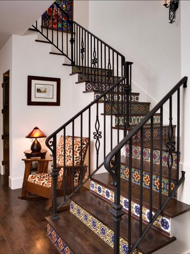 13 Spanish Style Living Room Decor Ideas with Warm Character 9 Staircase with colorful Talavera tile risers and black wrought iron railings