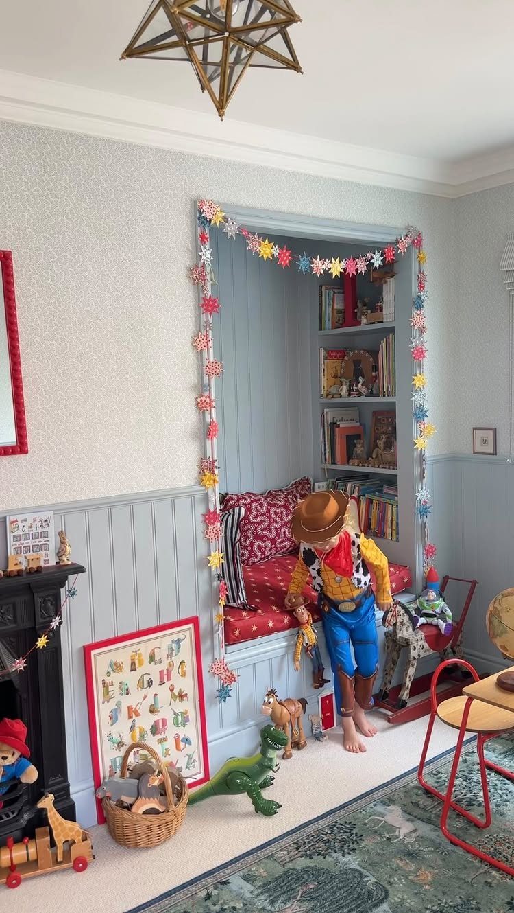 12 Toy Story Bedroom Ideas for Kids Who Love Woody and Buzz 10 Cozy built-in reading nook with red cushions and Toy Story characters in a bedroom.